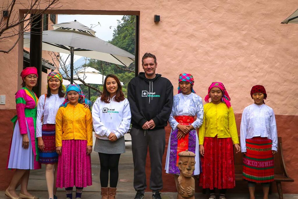 Team van Ha Giang Aya Lodge met lokale vrouwen in traditionele kleding.