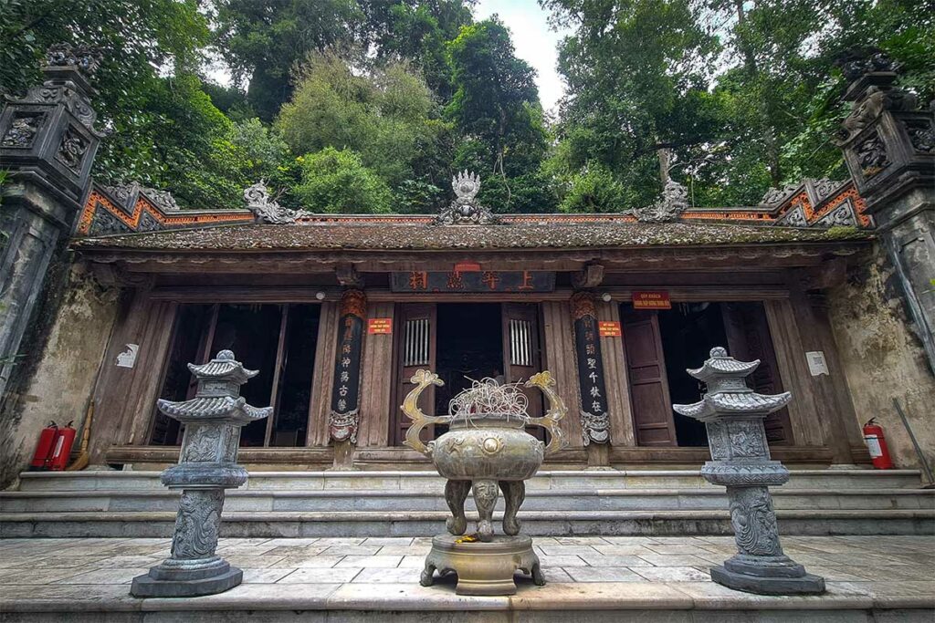 Duom-tempel aan de voet van Duom Mountain in Thai Nguyen, met stenen beelden en bosrijke achtergrond