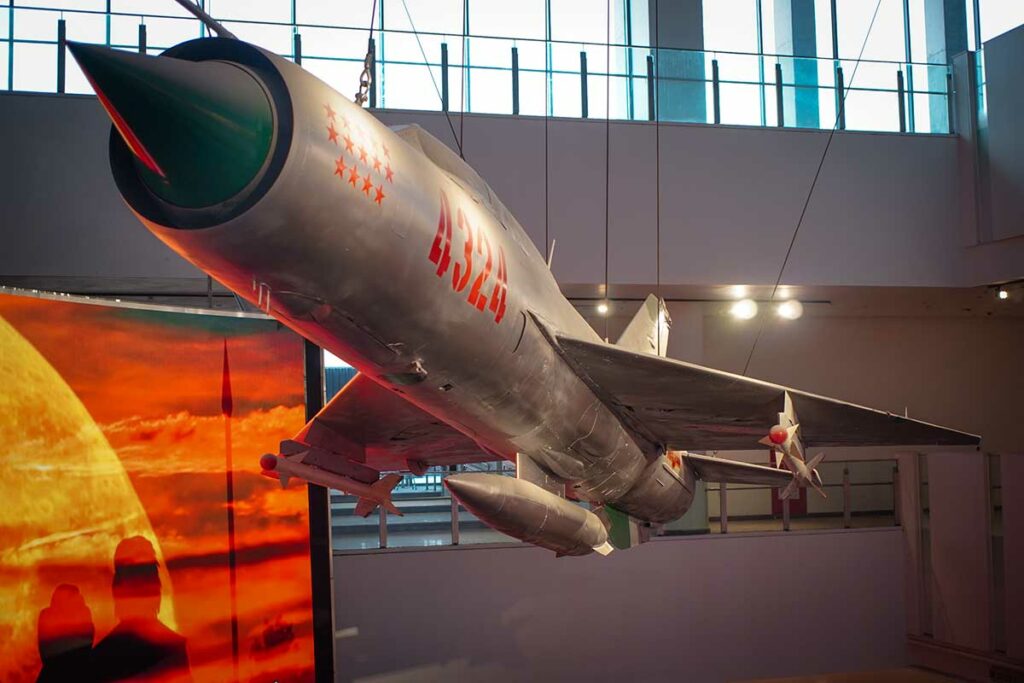 MiG-21 gevechtsvliegtuig tentoongesteld boven een grote digitale kaart in het Vietnam Military History Museum in Hanoi.