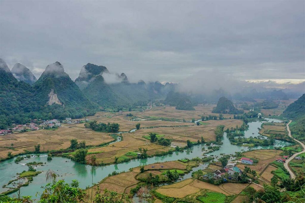 Panoramisch uitzicht vanaf het Phong Nam Valley viewpoint met kronkelende rivier, dorpen en rijstvelden tussen de bergen