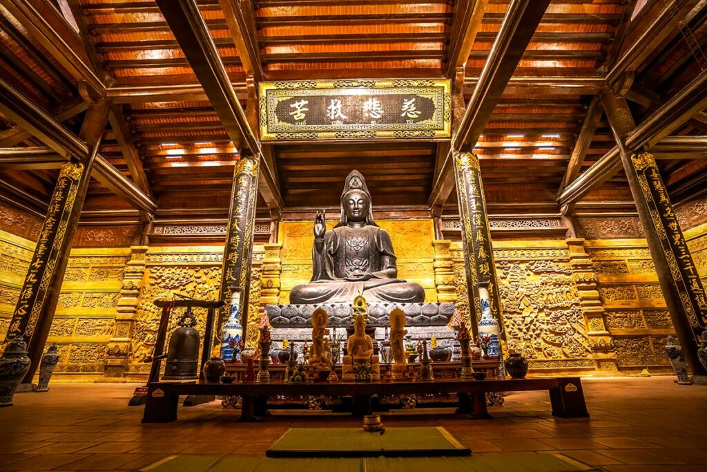 Shakyamuni Boeddha beeld in een tempel van Tam Chuc Pagoda met rijk versierde houten details