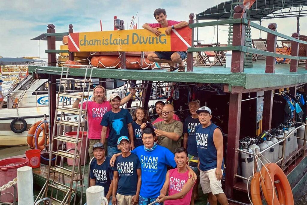 Het voltallige team van Cham Island Diving Center op hun boot in de haven van Hoi An — een van de grootste en meest ervaren duikorganisaties voor duiken bij de Cham eilanden